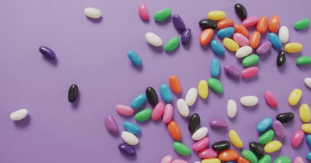 Video Overhead View Multi Coloured Sweets Falling Purple Background Fusion — Stock Video