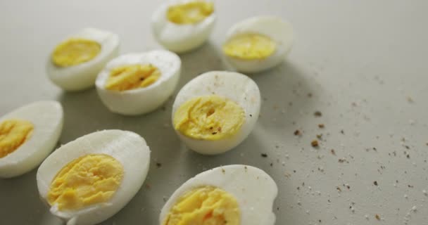 Video Close Peppered Halves Hard Boiled Eggs Grey Background Fusion — Stock Video