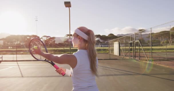 Video Back Caucasian Female Tennis Player Holding Racket Hitting Ball — Stock Video