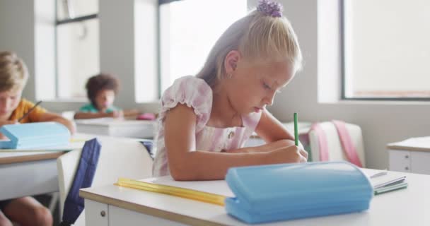 Video Focused Caucasian Girl Sitting Desk Classroom Primary School Education — стоковое видео