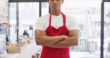 Animation of happy biracial waiter standing in coffee shop. coffee and bistro shop, running small independent business.