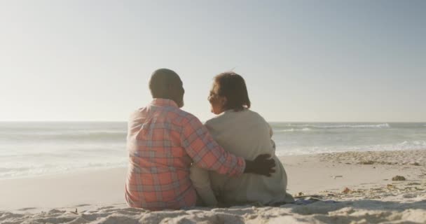 笑顔のシニアアフリカ系アメリカ人のカップルを受け入れ 日当たりの良いビーチに座っている 健康的で活発な退職ビーチの休日 — ストック動画