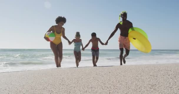 Smiling African American Family Inflatables Running Sunny Beach Healthy Active — Vídeo de stock