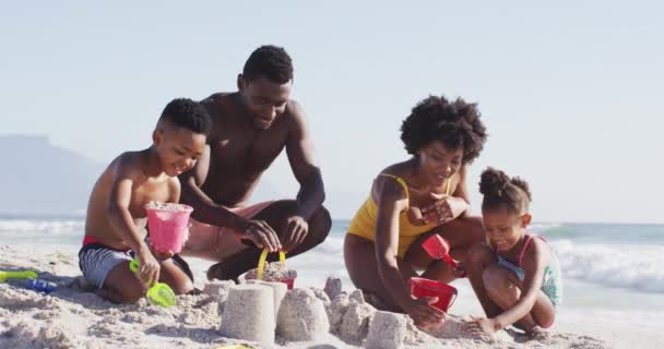 Smiling African American Family Building Sandcastle American Flag Sunny Beach — Stock video