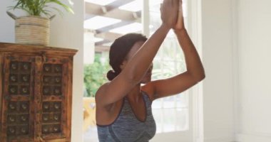 Evde yoga yapan rahat bir Afrikalı Amerikalı kadının videosu. aktif sağlıklı yaşam tarzı, evde egzersiz.