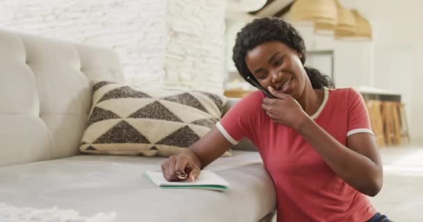 Video Happy African American Woman Sitting Floor Using Smartphone Making — Stockvideo