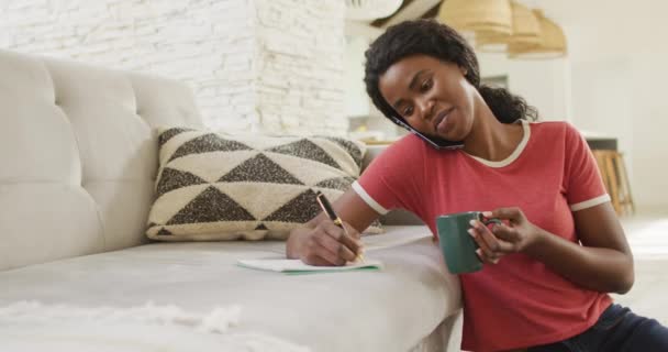 Video Happy African American Woman Sitting Floor Using Smartphone Making — Stockvideo