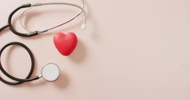 Video Close Stethoscope Heart Pink Background Global Medicine Healthcare Concept — Vídeo de Stock