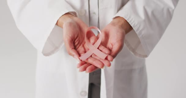 Video Biracial Female Doctor Holding Pink Breast Cancer Ribbon Global — Stockvideo