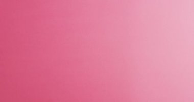 Video of hands of caucasian woman holding pink ribbon on pink background. medicine, health, cancer awareness concept digitally generated video.