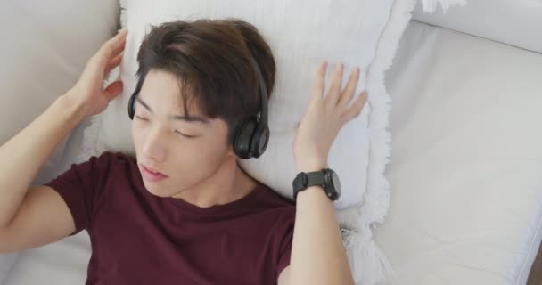 Asian Male Teenager Listening Music Headphones Living Room Spending Time — Wideo stockowe