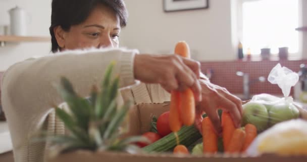 Smiling Senior Biracial Woman Grabbing Vegetables Kitchen Alone Healthy Active — Stock video