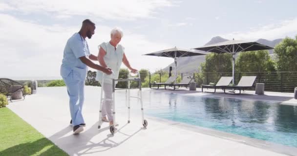 Video Happy African American Male Doctor Taking Care Caucasian Senior — Stok video