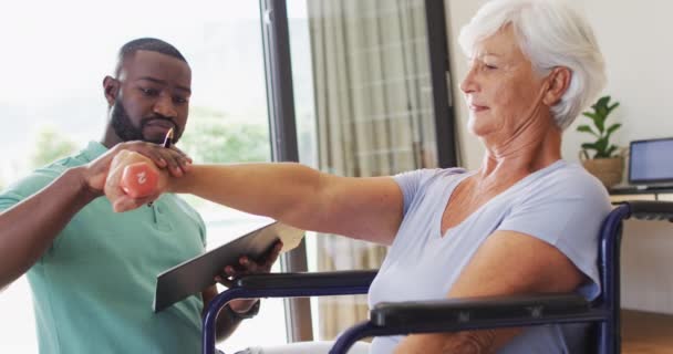 Video Happy African American Male Physiotherapist Exercising Caucasian Senior Woman — Αρχείο Βίντεο