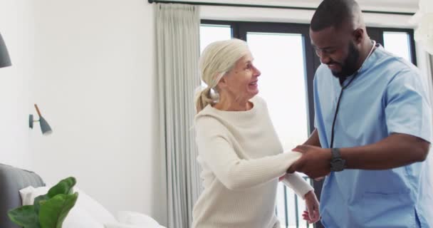 Video Happy African American Male Doctor Taking Care Caucasian Senior — Αρχείο Βίντεο