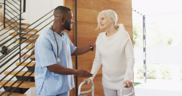 Video Happy African American Male Doctor Taking Care Caucasian Senior — Videoclip de stoc