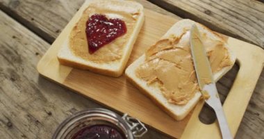 Close up view of peanut butter and jelly sandwiches on wooden tray on wooden surface. food and nutrition concept