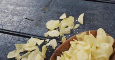 Tahta yüzeyinde fotokopi alanı olan bir kasedeki patates cipslerinin yakın görüntüsü. yiyecek ve atıştırmalık konsepti
