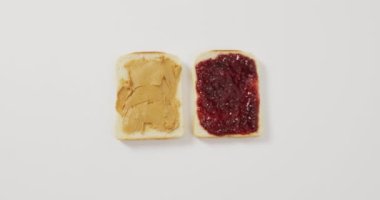 Close up view of peanut butter and jelly sandwiches  with copy space on white surface. food and nutrition concept