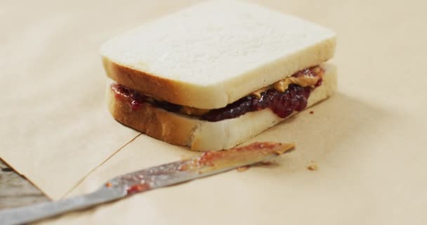 Close Peanut Butter Jelly Sandwich Butter Knife Wooden Tray Food — стоковое видео