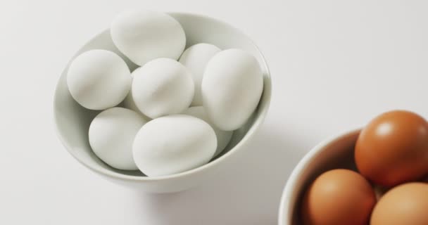 Close Two Bowls Full Brown White Eggs Copy Space White — Video