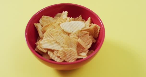 将薯片放入碗中 在黄色表面留有复制空间 食品和小吃概念 — 图库视频影像