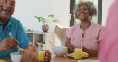 Happy senior diverse people having breakfast at retirement home. healthy, active retirement and body inclusivity.