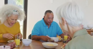 Happy senior diverse people having breakfast at retirement home. healthy, active retirement and body inclusivity.