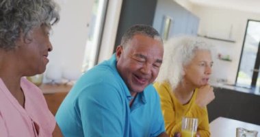 Happy senior diverse people having breakfast at retirement home. healthy, active retirement and body inclusivity.