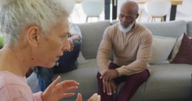 Senior diverse people at meeting talking at retirement home. healthy, active retirement and body inclusivity.