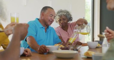 Happy senior diverse people having breakfast at retirement home. healthy, active retirement and body inclusivity.