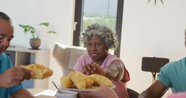 Happy senior diverse people having breakfast at retirement home. healthy, active retirement and body inclusivity.