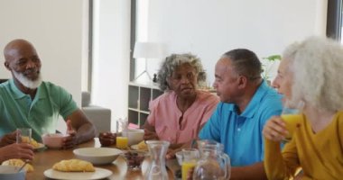 Happy senior diverse people having breakfast at retirement home. healthy, active retirement and body inclusivity.