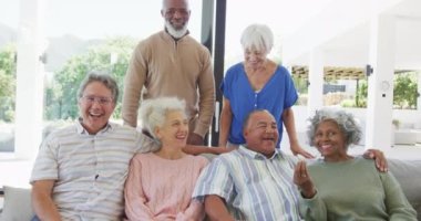 Portrait of senior diverse people embracing at retirement home. healthy, active retirement and body inclusivity.