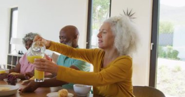 Happy senior diverse people having breakfast at retirement home. healthy, active retirement and body inclusivity.