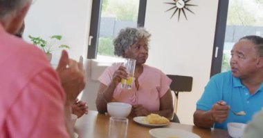 Happy senior diverse people having breakfast at retirement home. healthy, active retirement and body inclusivity.