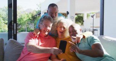 Happy senior diverse people taking selfie at retirement home. healthy, active retirement and body inclusivity.