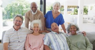 Portrait of senior diverse people embracing at retirement home. healthy, active retirement and body inclusivity.
