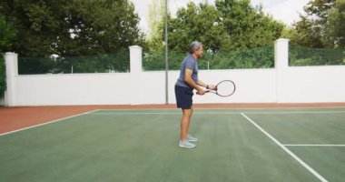Raket tutan ve tenis kortunda maça başlayan son sınıf öğrencisinin videosu. aktif emeklilik yaşam tarzı, kıdemli ilişki ve tenis eğitim konsepti.