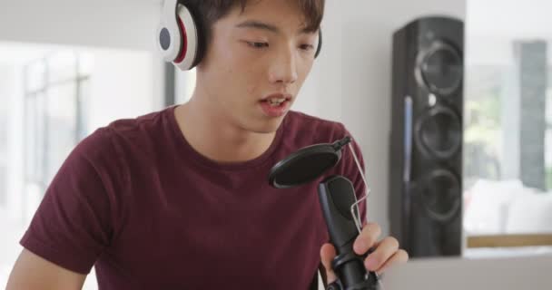 Asian Boy Wearing Headphones Speaking Professional Microphone Record Audio Podcast — 图库视频影像