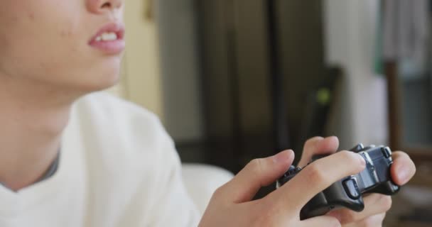 Close Asian Boy Wearing Headphones Playing Video Games Sitting Couch — Stockvideo