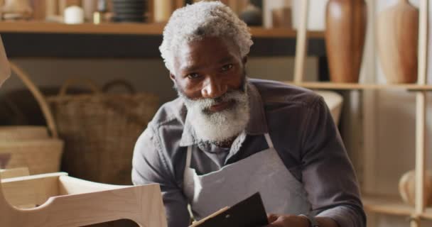 Retrato Carpintero Masculino Afroamericano Con Portapapeles Sonriendo Sentado Una Carpintería — Vídeo de stock