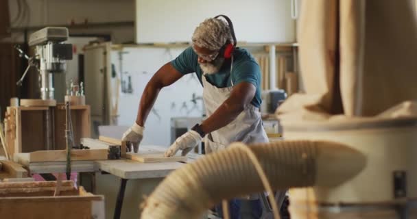 African American Male Carpenter Using Table Saw Cutting Wood Carpentry — Stock videók