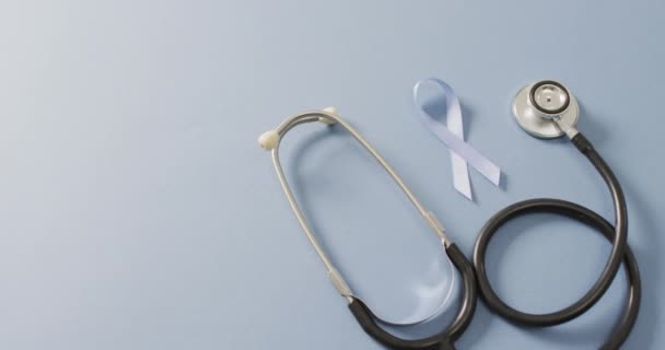 Video Stethoscope Pale Blue Prostate Cancer Ribbon Pale Blue Background — Vídeo de Stock