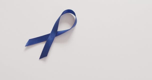 Video Dark Blue Colon Cancer Ribbon White Background Medical Healthcare — Stockvideo