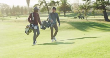 Farklı erkek arkadaşların golf sahasında yürüdüğü bir video. spor, aktif yaşam tarzı ve golf konsepti.