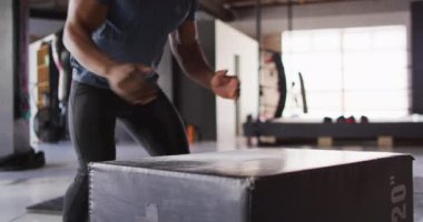 Formda olan Afro-Amerikan bir adamın spor salonunda atlama videosu. aktif, formda, sportif ve sağlıklı yaşam tarzı, spor konsepti egzersizi.
