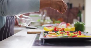 Sebze salatasının üzerine otlar serpiştiren Asyalı yaşlı kadının orta bölümü. emeklilik yaşam tarzı ve yaşam konsepti