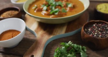 Tahta yüzeyde yatmakta olan köri kasesinin yeni hazırlanmış videosu. Mutfak, yemek, yemek hazırlama, tat ve lezzet konsepti.