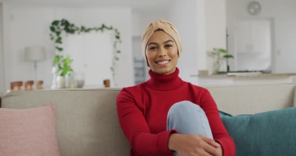 Video Lycklig Biracial Kvinna Hijab Sitter Soffan Och Tittar Kameran — Stockvideo